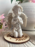 praying cherub with cross